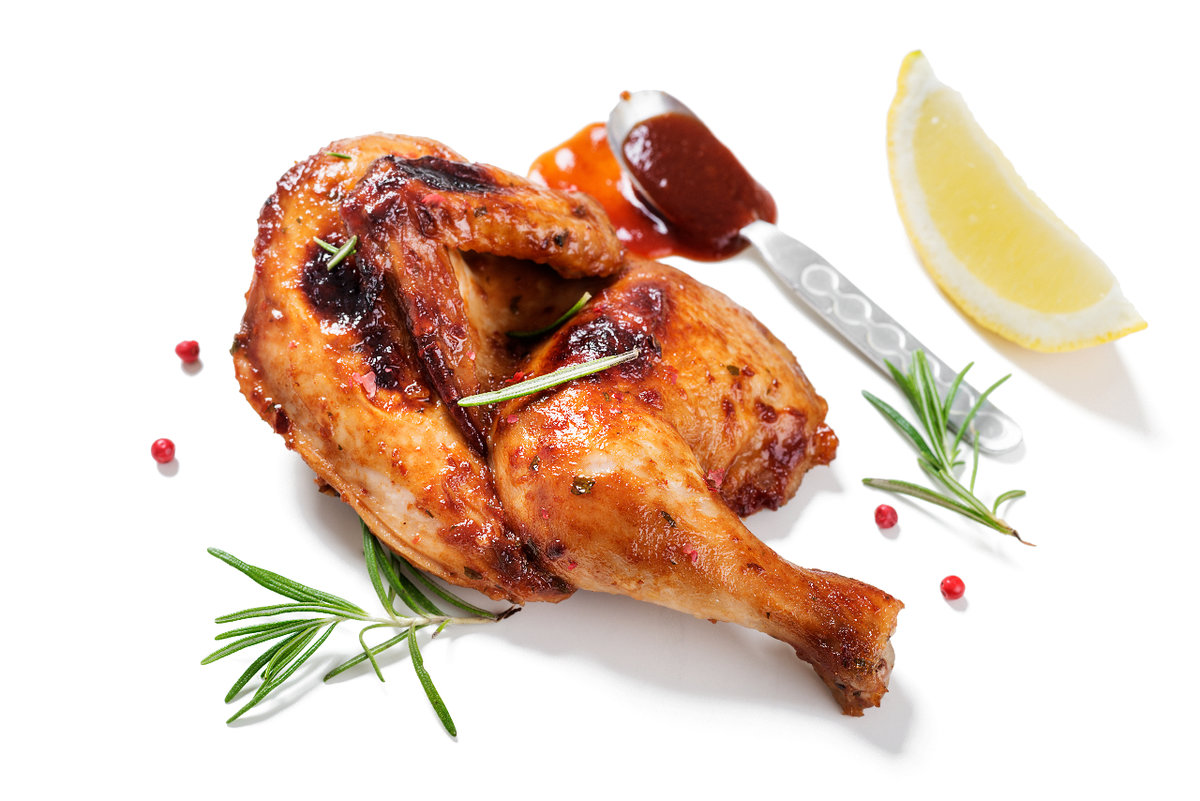  grilled chicken with lemon slices, barbeque sauce and rosemary.